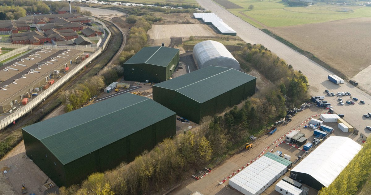 Impressive facade of Bovingdon Airfield Studios showing large sound stages from an aerial perspective